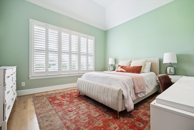 5420 Maple St, Bellaire, TX 77401 - bedroom with multiple windows, light wood-style floors, baseboards, and crown molding