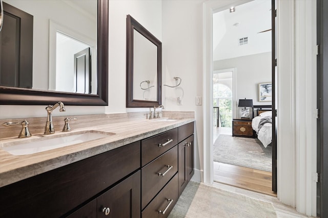 5420 Maple St, Bellaire, TX 77401 - bathroom featuring double vanity, ensuite bathroom, and crown molding