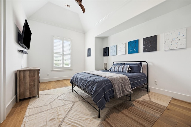 5420 Maple St, Bellaire, TX 77401 - bedroom with vaulted ceiling, wood finished floors, baseboards, and ceiling fan