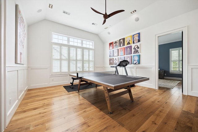 5420 Maple St, Bellaire, TX 77401 - rec room with a ceiling fan, lofted ceiling, light wood-style flooring, a decorative wall, and wainscoting