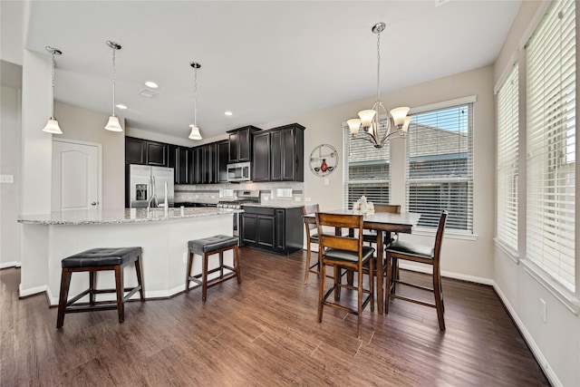 2635 Cedar Path Ln, Conroe, TX 77385 - dining area featuring a chandelier, dark wood-type flooring, recessed lighting, and baseboards