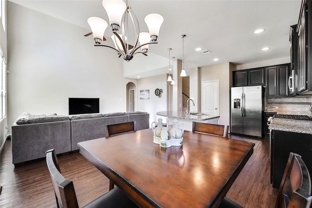 2635 Cedar Path Ln, Conroe, TX 77385 - dining space featuring arched walkways, a chandelier, dark wood-type flooring, and recessed lighting