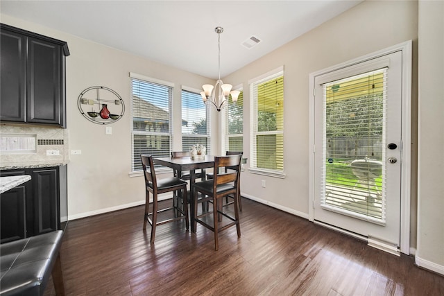 2635 Cedar Path Ln, Conroe, TX 77385 - dining area featuring a chandelier, dark wood-style floors, and baseboards