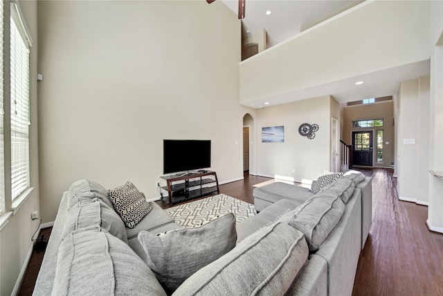 2635 Cedar Path Ln, Conroe, TX 77385 - living room featuring arched walkways, baseboards, a towering ceiling, dark wood-style floors, and recessed lighting