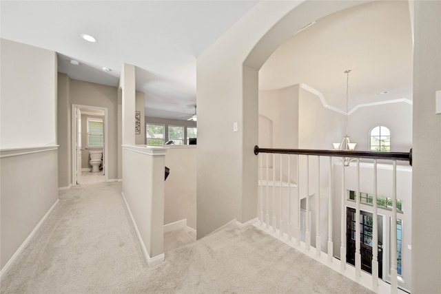 2635 Cedar Path Ln, Conroe, TX 77385 - hallway with an upstairs landing, carpet flooring, arched walkways, baseboards, and recessed lighting