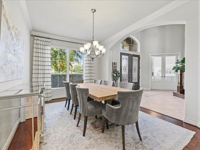 20326 Scarlett Saddle Ct, Cypress, TX 77433 - dining area featuring french doors, a chandelier, crown molding, hardwood / wood-style flooring, and baseboards
