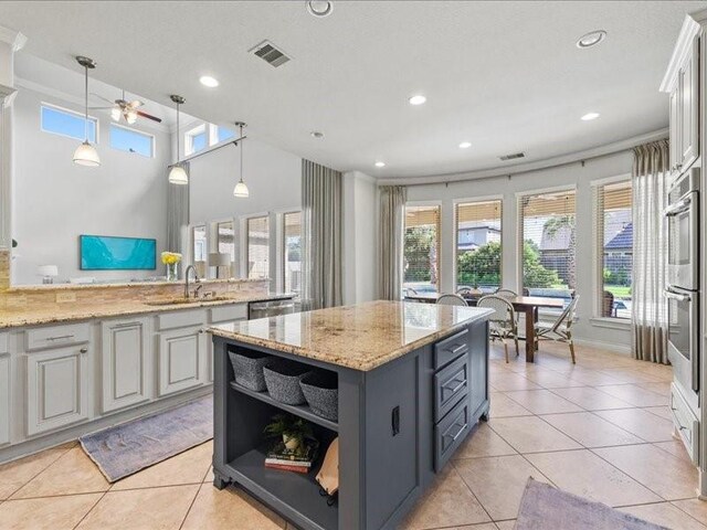 20326 Scarlett Saddle Ct, Cypress, TX 77433 - kitchen featuring a sink, double oven, recessed lighting, plenty of natural light, and a center island