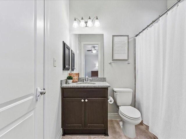 20326 Scarlett Saddle Ct, Cypress, TX 77433 - full bathroom with vanity, toilet, a ceiling fan, baseboards, and curtained shower