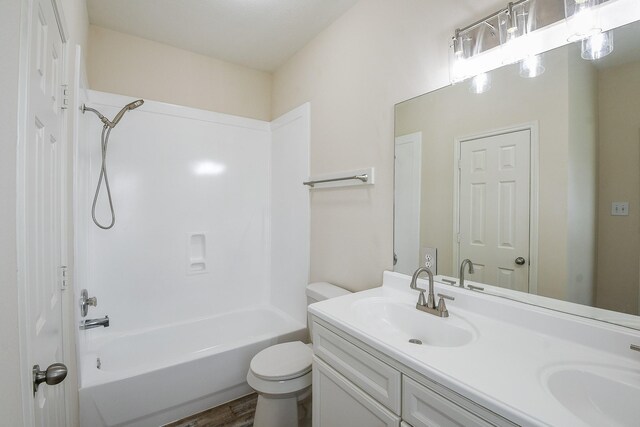 9203 Windy Spring Ct, Houston, TX 77089 - bathroom featuring double vanity, washtub / shower combination, toilet, and wood finished floors
