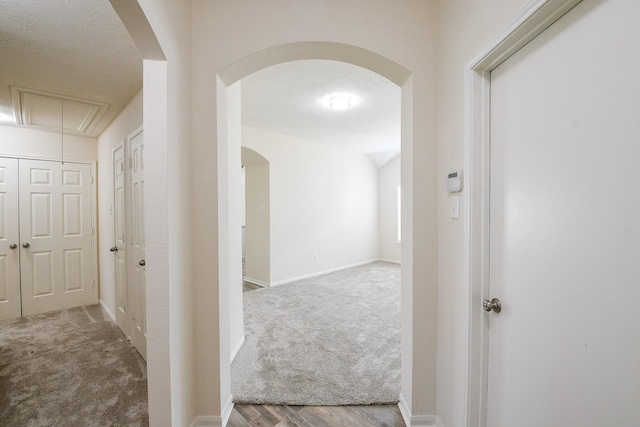 9203 Windy Spring Ct, Houston, TX 77089 - corridor featuring carpet flooring, attic access, arched walkways, and baseboards