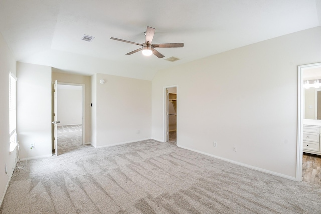 9203 Windy Spring Ct, Houston, TX 77089 - unfurnished bedroom featuring light carpet, a spacious closet, ensuite bathroom, baseboards, and vaulted ceiling