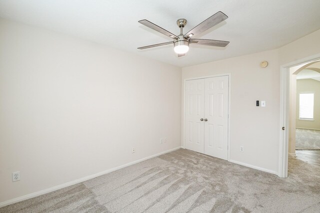 9203 Windy Spring Ct, Houston, TX 77089 - unfurnished bedroom featuring arched walkways, light carpet, a closet, baseboards, and ceiling fan