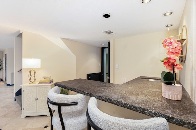 18138 Bal Harbour Dr, Houston, TX 77058 - kitchen with dark countertops, recessed lighting, a breakfast bar, and white cabinets