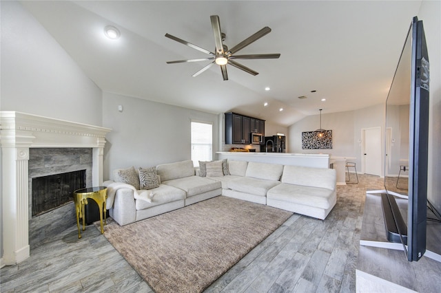 21811 Blossom Grove Ln, Spring, TX 77379 - living area featuring vaulted ceiling, ceiling fan, light wood finished floors, a premium fireplace, and recessed lighting