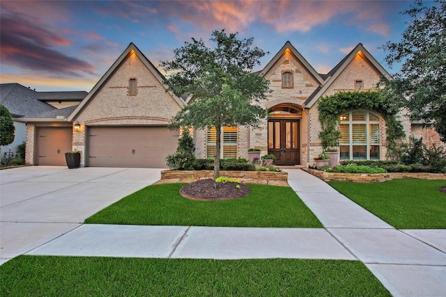 7118 Kinglet Ct, Katy, TX 77493 - french provincial home featuring french doors, a garage, stone siding, a front yard, and brick siding