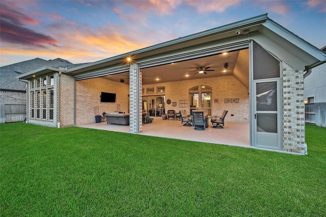 7118 Kinglet Ct, Katy, TX 77493 - back of property at dusk with a patio area and a ceiling fan