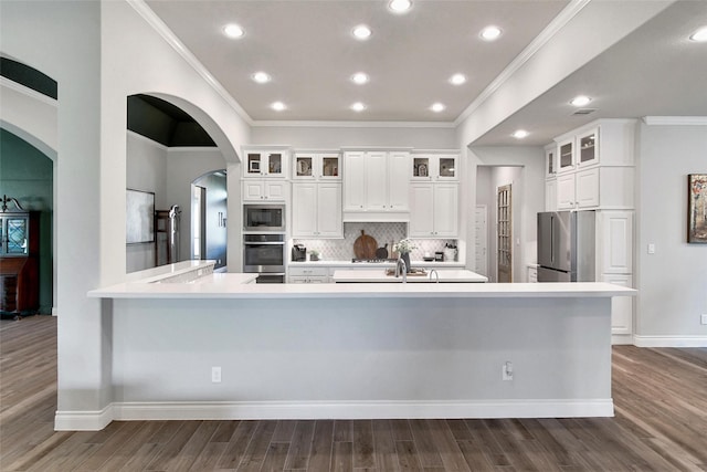 7118 Kinglet Ct, Katy, TX 77493 - kitchen with stainless steel appliances, dark wood-style floors, crown molding, white cabinets, and light countertops