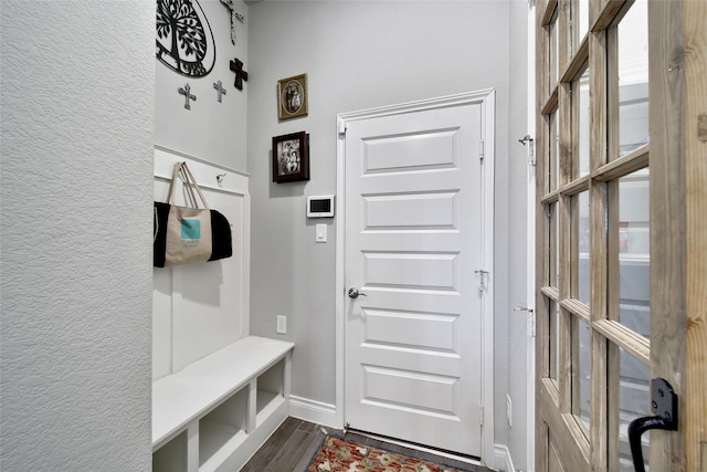 7118 Kinglet Ct, Katy, TX 77493 - mudroom featuring dark wood-type flooring, baseboards, and a textured wall