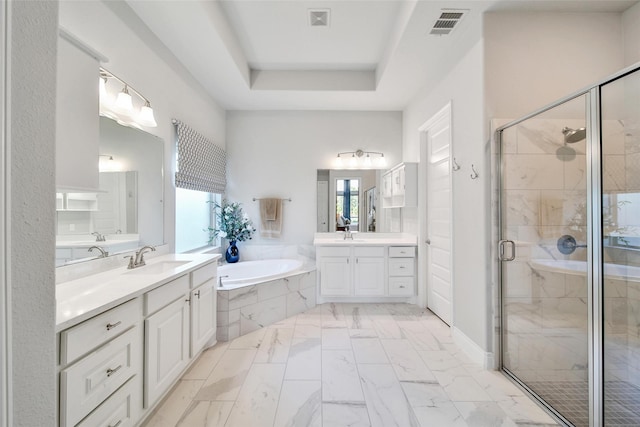 7118 Kinglet Ct, Katy, TX 77493 - full bathroom featuring a garden tub, two vanities, a stall shower, marble finish floors, and a tray ceiling