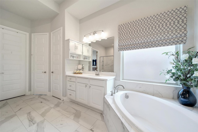 7118 Kinglet Ct, Katy, TX 77493 - bathroom featuring a garden tub, vanity, marble look tiles, and a shower