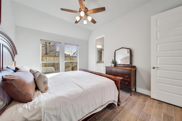 7118 Kinglet Ct, Katy, TX 77493 - bedroom featuring wood finished floors, lofted ceiling, baseboards, connected bathroom, and a ceiling fan