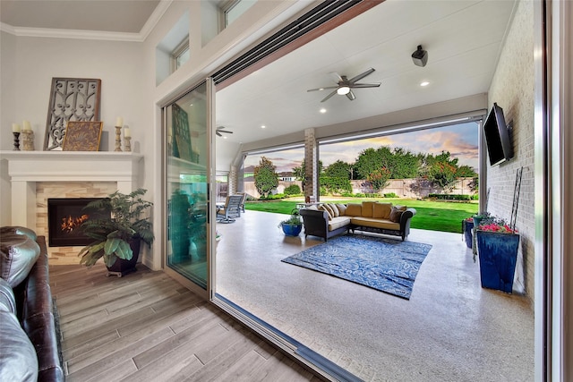 7118 Kinglet Ct, Katy, TX 77493 - living area with ornamental molding, wood finished floors, a ceiling fan, and a tile fireplace