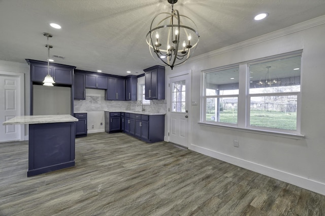 7437 Navasota St, Houston, TX 77016 - kitchen with a sink, a chandelier, crown molding, dark wood-style flooring, and baseboards