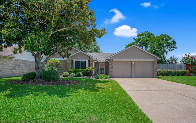 2123 Fountain Dr, Sugar Land, TX 77478 - ranch-style house with brick siding, an attached garage, and driveway