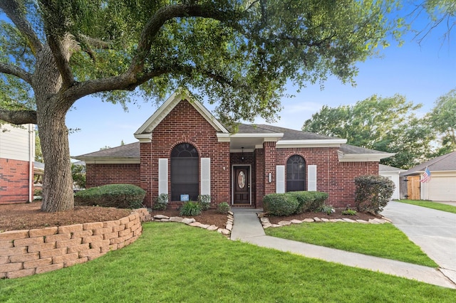 6119 Plantation Bay Dr, Katy, TX 77449 - view of front facade with brick siding, a front yard, roof with shingles, and driveway