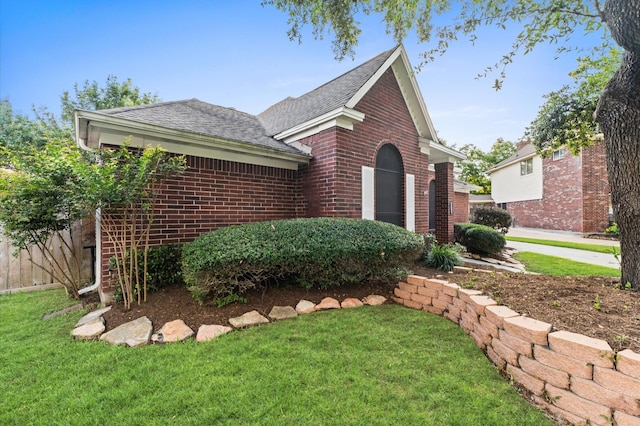 6119 Plantation Bay Dr, Katy, TX 77449 - view of front of home featuring brick siding, a shingled roof, and a front lawn