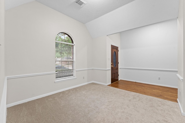 6119 Plantation Bay Dr, Katy, TX 77449 - empty room featuring carpet flooring, lofted ceiling, and baseboards