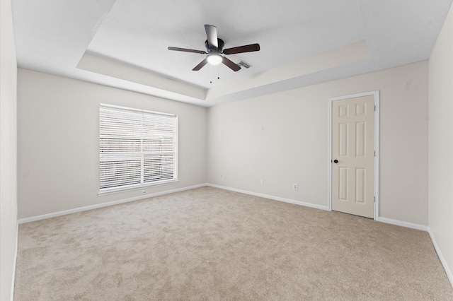 6119 Plantation Bay Dr, Katy, TX 77449 - empty room featuring a raised ceiling, carpet, ceiling fan, and baseboards