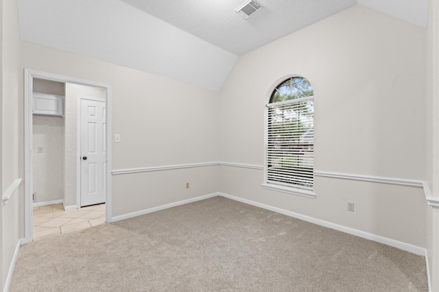 6119 Plantation Bay Dr, Katy, TX 77449 - empty room featuring vaulted ceiling, light colored carpet, and baseboards