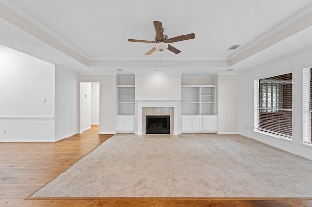 6119 Plantation Bay Dr, Katy, TX 77449 - unfurnished living room with ceiling fan, baseboards, light wood-style flooring, crown molding, and a tiled fireplace