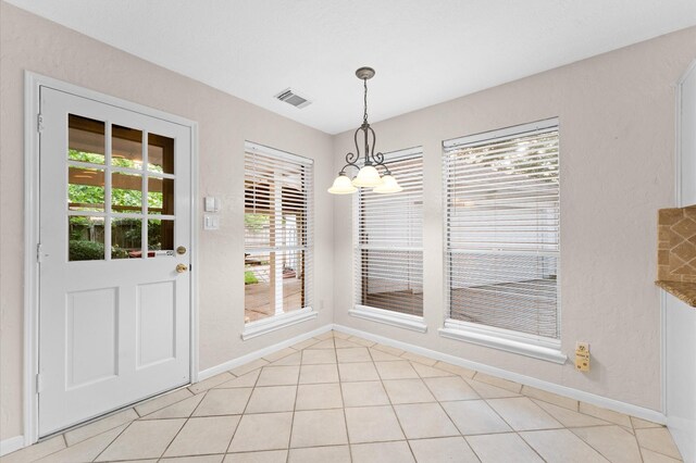 6119 Plantation Bay Dr, Katy, TX 77449 - unfurnished dining area featuring a chandelier, baseboards, and light tile patterned flooring