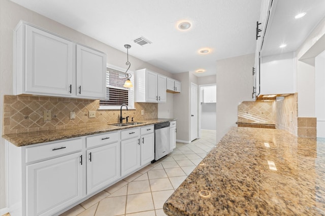 6119 Plantation Bay Dr, Katy, TX 77449 - kitchen featuring stainless steel dishwasher, a sink, stone counters, tasteful backsplash, and white cabinets