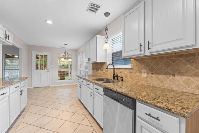 6119 Plantation Bay Dr, Katy, TX 77449 - kitchen featuring stainless steel dishwasher, a sink, backsplash, white cabinetry, and pendant lighting