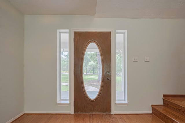 144 Pin Oak Ln, Hempstead, TX 77445 - entryway with light wood finished floors, baseboards, and stairs