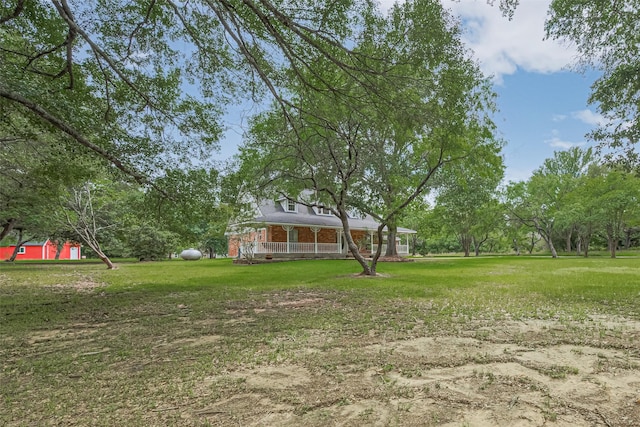 144 Pin Oak Ln, Hempstead, TX 77445 - view of green lawn with covered porch