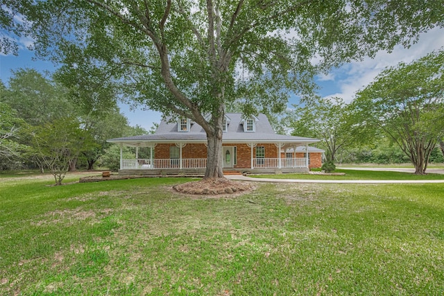 144 Pin Oak Ln, Hempstead, TX 77445 - view of front of house featuring a porch, brick siding, and a front yard