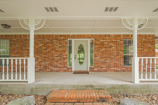 144 Pin Oak Ln, Hempstead, TX 77445 - property entrance with a porch and brick siding