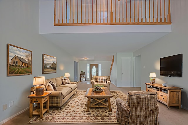 144 Pin Oak Ln, Hempstead, TX 77445 - carpeted living area featuring baseboards and a towering ceiling