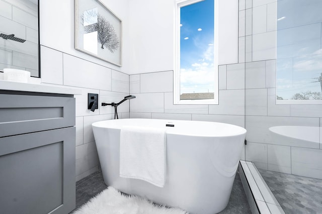 3808 Jefferson St, Houston, TX 77003 - bathroom featuring tile walls, vanity, and a freestanding tub
