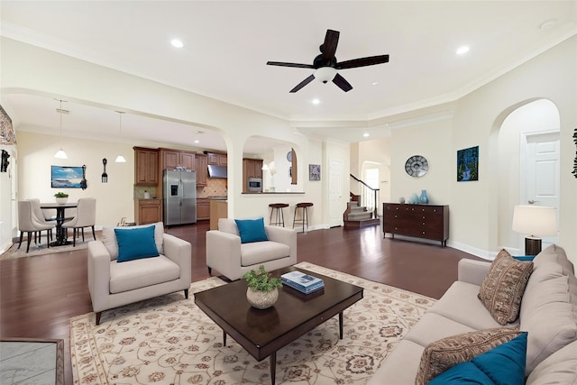 3730 Arundel Gardens Ln, Sugar Land, TX 77498 - living room with arched walkways, wood finished floors, a ceiling fan, recessed lighting, and stairway