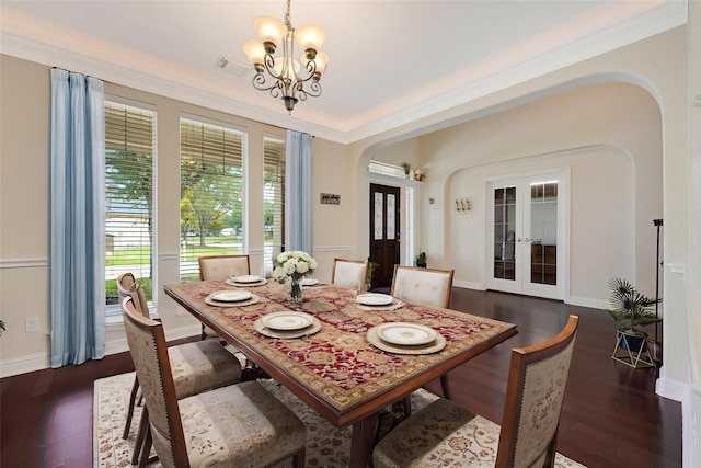 3730 Arundel Gardens Ln, Sugar Land, TX 77498 - dining area with arched walkways, french doors, a chandelier, dark wood finished floors, and crown molding