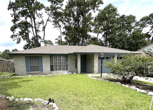 9530 Landry Blvd, Spring, TX 77379 - ranch-style house featuring a front yard, a chimney, and a shingled roof