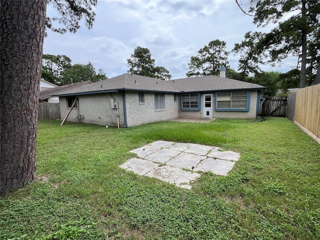 9530 Landry Blvd, Spring, TX 77379 - back of property with a patio area, brick siding, a chimney, and a shingled roof