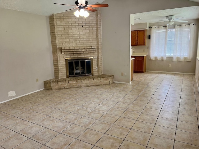 9530 Landry Blvd, Spring, TX 77379 - unfurnished living room with a ceiling fan, light tile patterned floors, lofted ceiling, a fireplace, and a textured ceiling