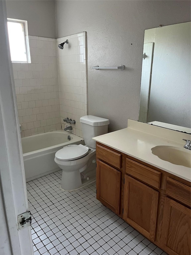 9530 Landry Blvd, Spring, TX 77379 - bathroom featuring vanity, toilet, shower / washtub combination, tile patterned flooring, and a textured wall
