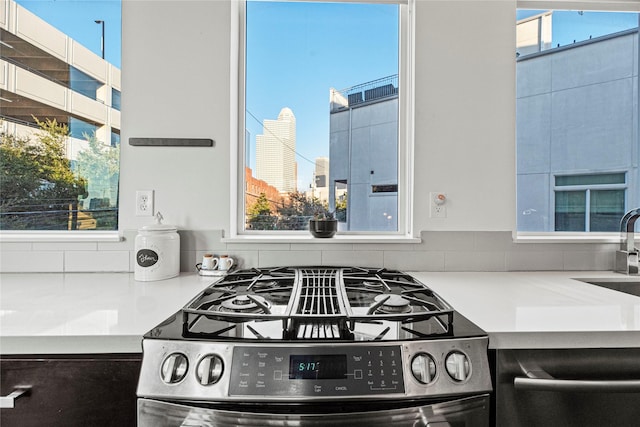 104 Pierce St, Houston, TX 77002 - kitchen featuring stainless steel range with gas cooktop, a sink, and light countertops